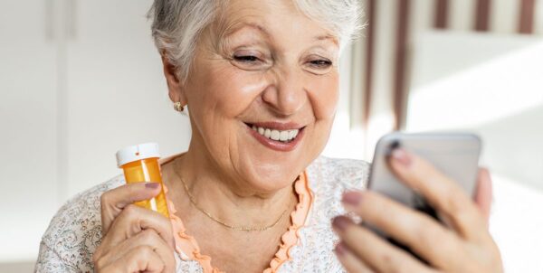 older-woman-using-phone-medications
